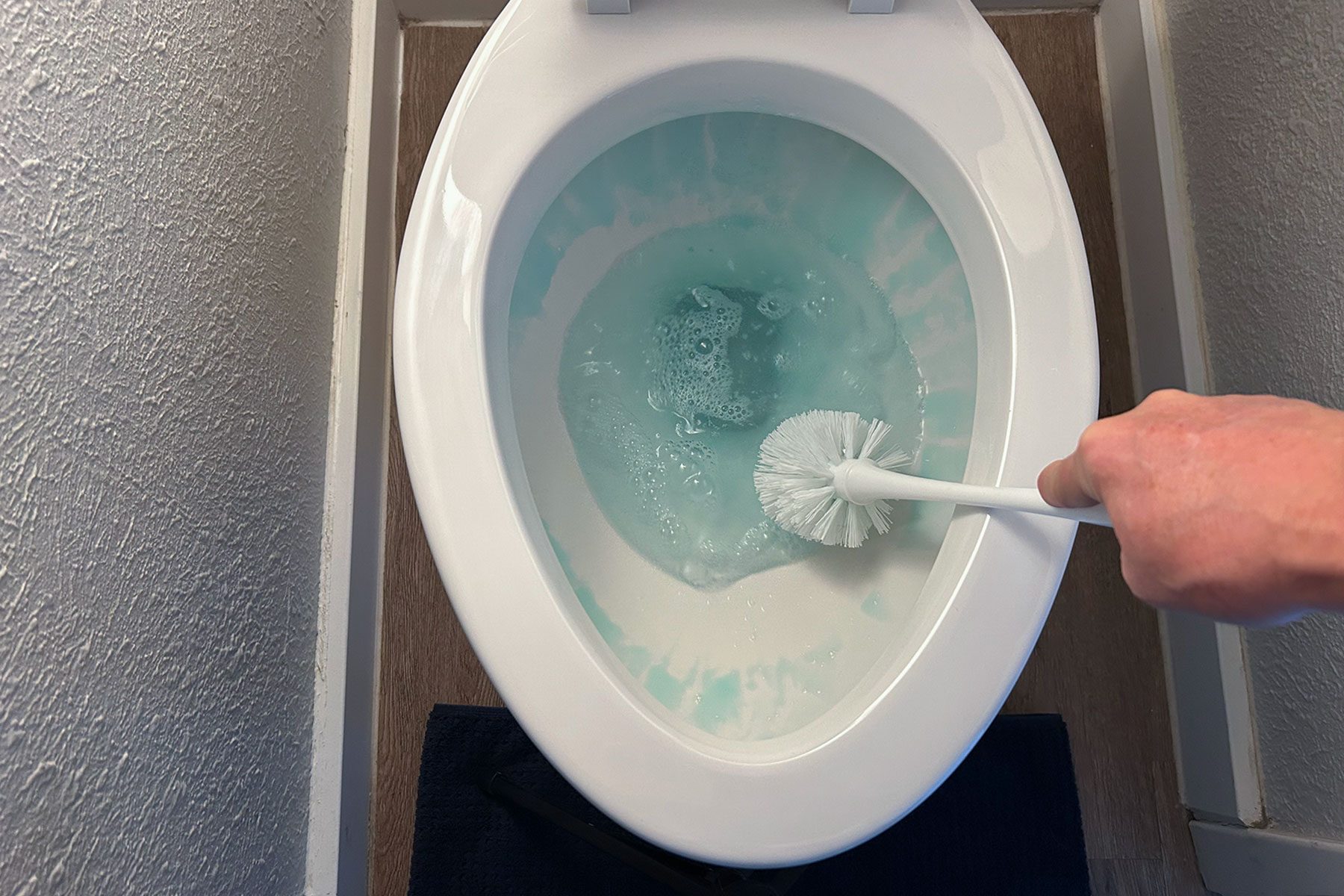 Cleaning the toilet with brush