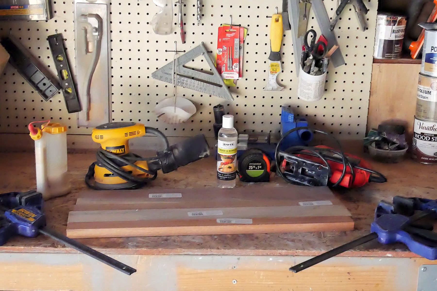 A workbench with a variety of tools on it.