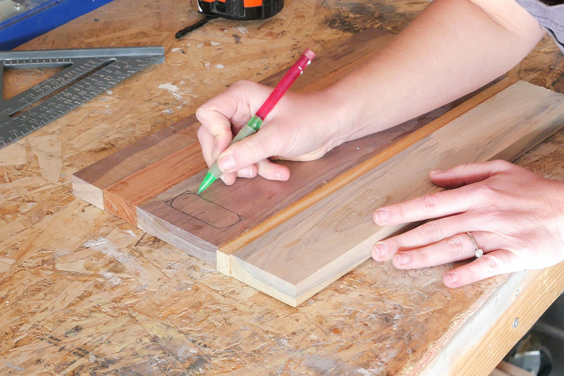 Making marks on wooden board with pencil