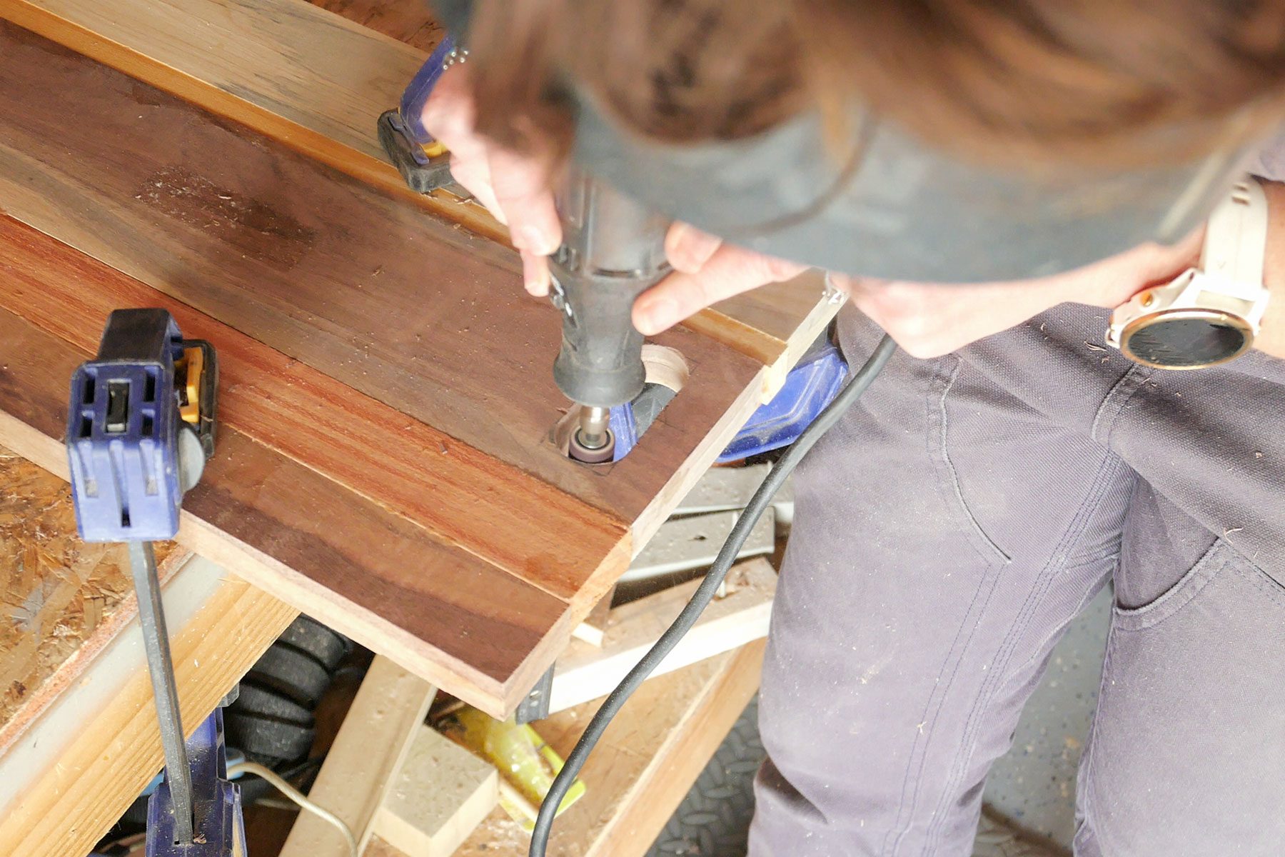 Sanding the handle hole of the wooden board