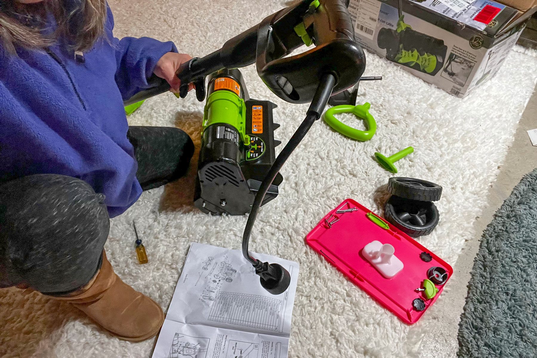 A woman assembling the Earthwise Electric Snow Shovel