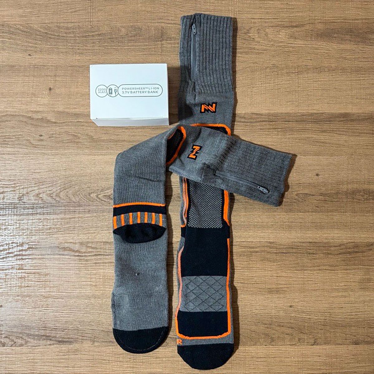 Fieldsheer Mobile Warming Heated Wool Socks lying on wooden surface