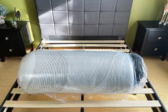 Nolah Mattress wrapped in plastic on a bed frame