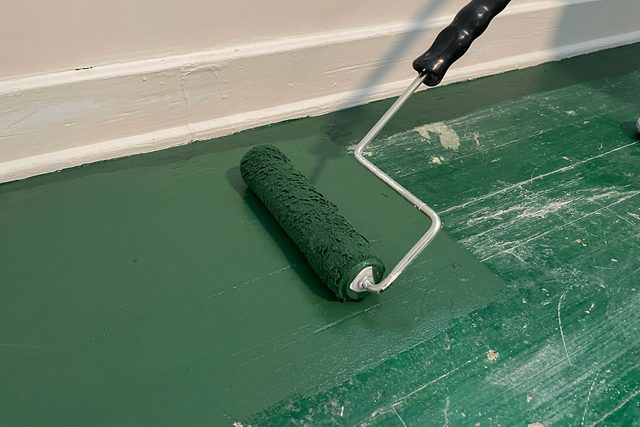 Painting the floor with paint roller