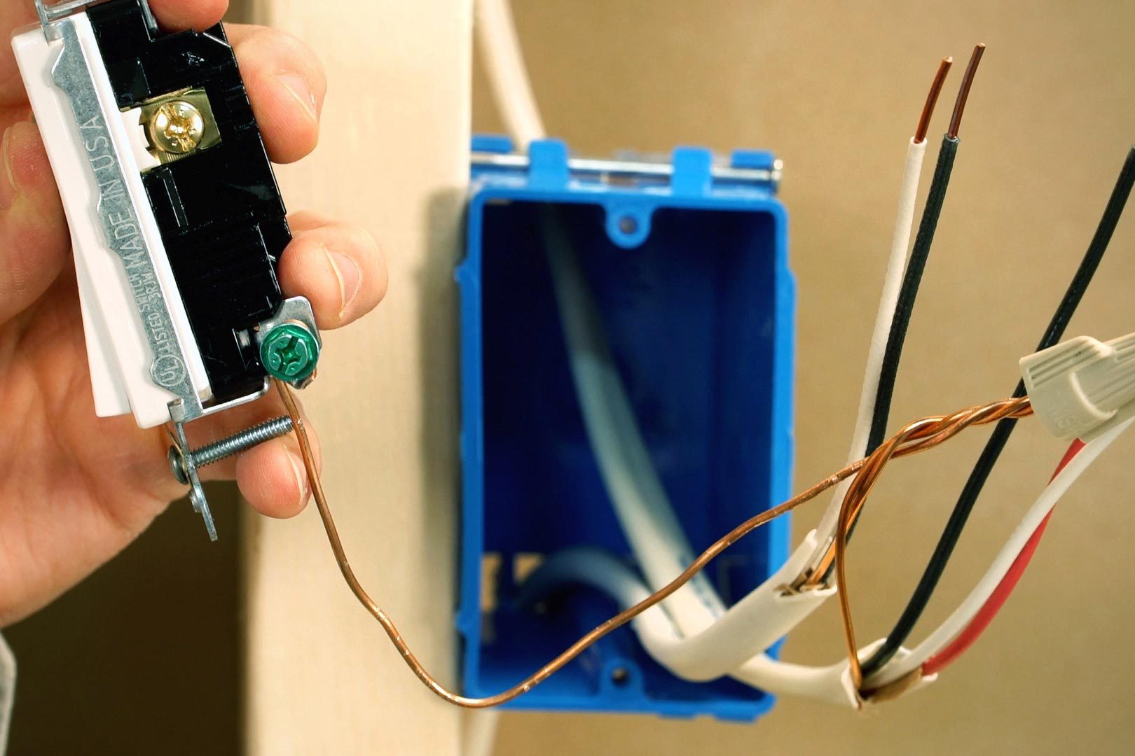 wire wrapped around a green screw on the switch