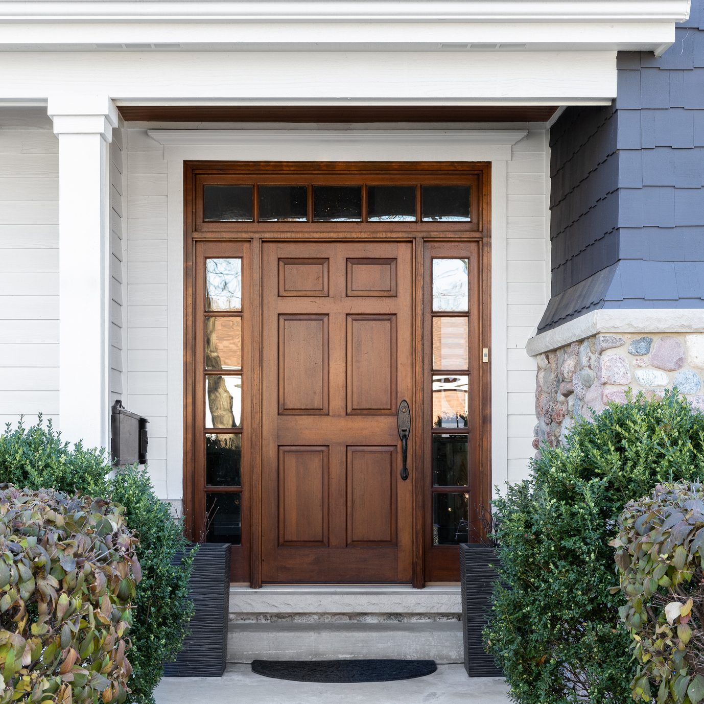 A blue house with a wooden front door.