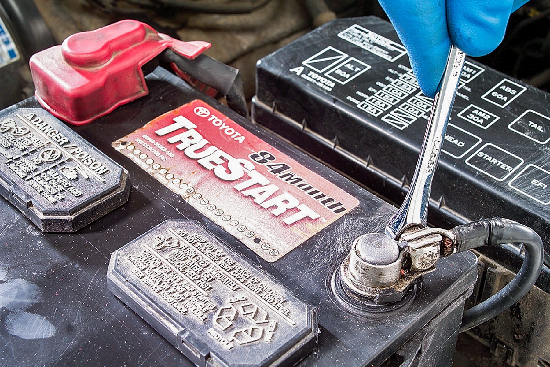 Loosening Negative Battery Terminal with Combination Wrench