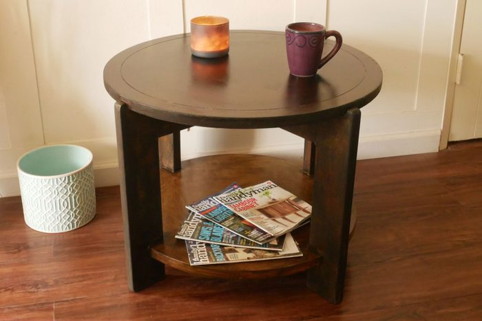 A cup and a candle place on a wooden table