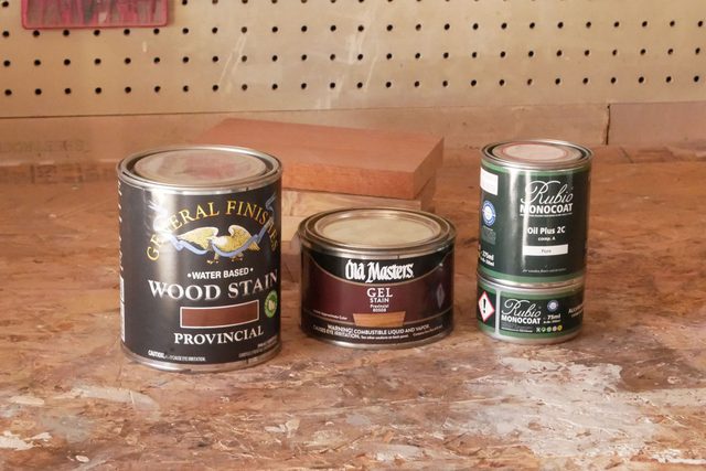 Stain tins placed on a wooden table