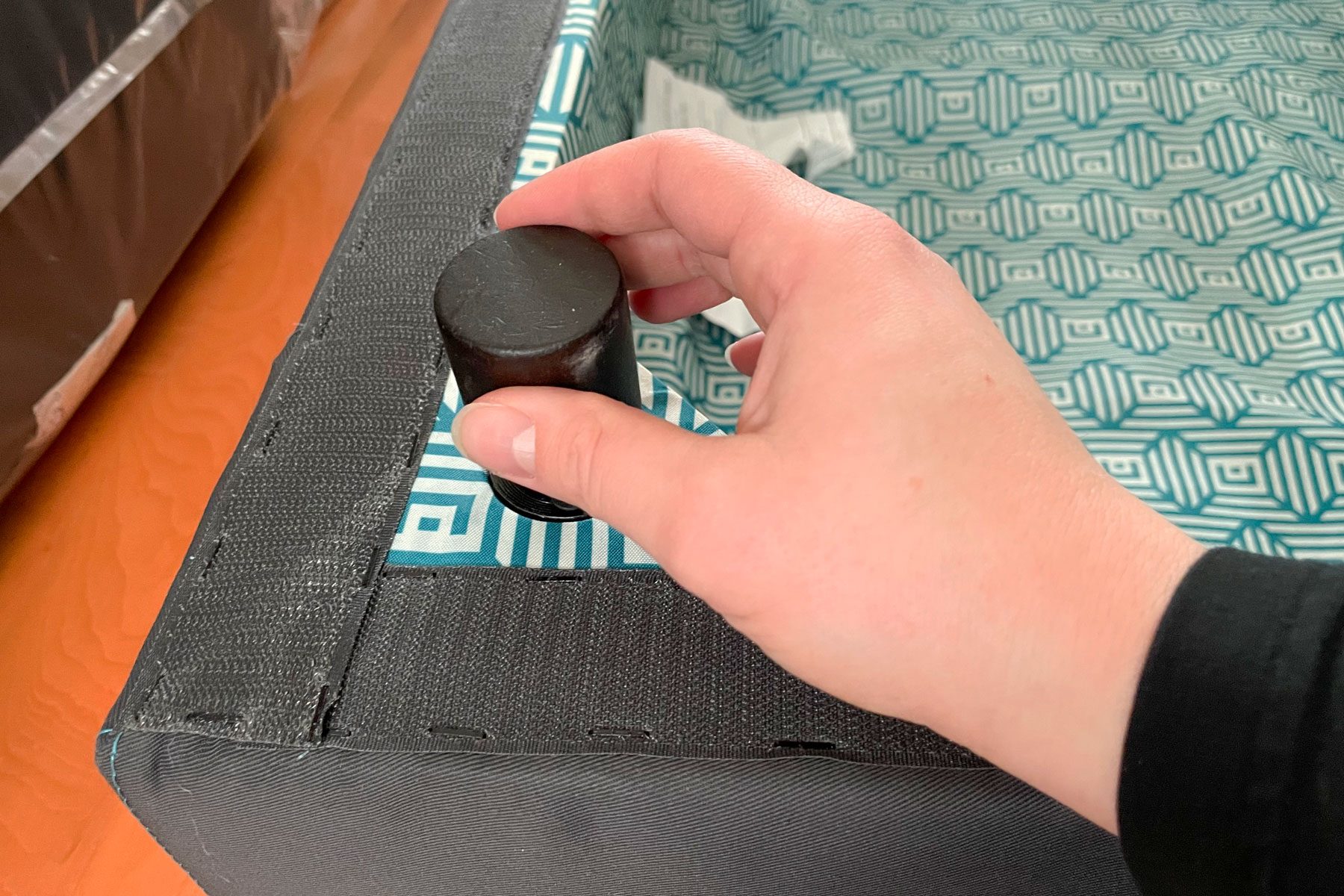 A person assembling the bottom of the Lovesac Sactional sofa