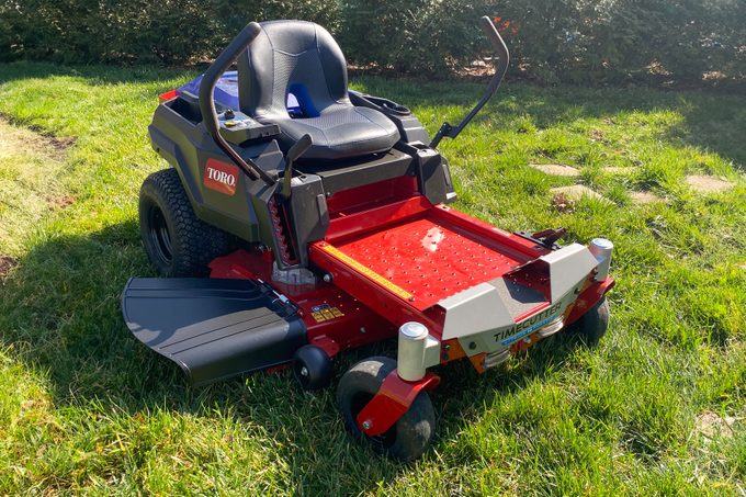 A red Toro Electric Zero Turn Mower in frond yard.
