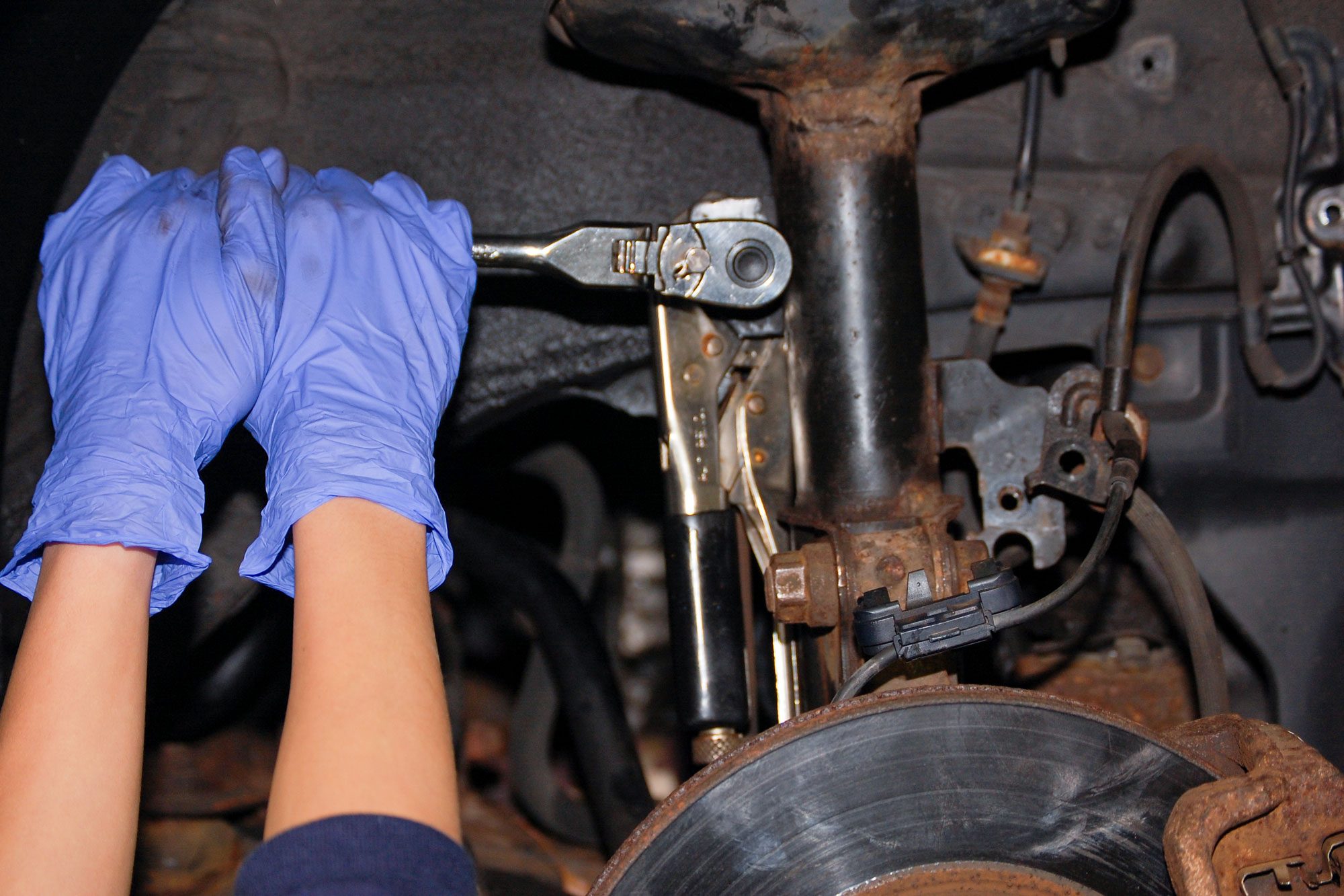 a person using vice-grips (locking pliers) to hold a loose/worn ball socket stud