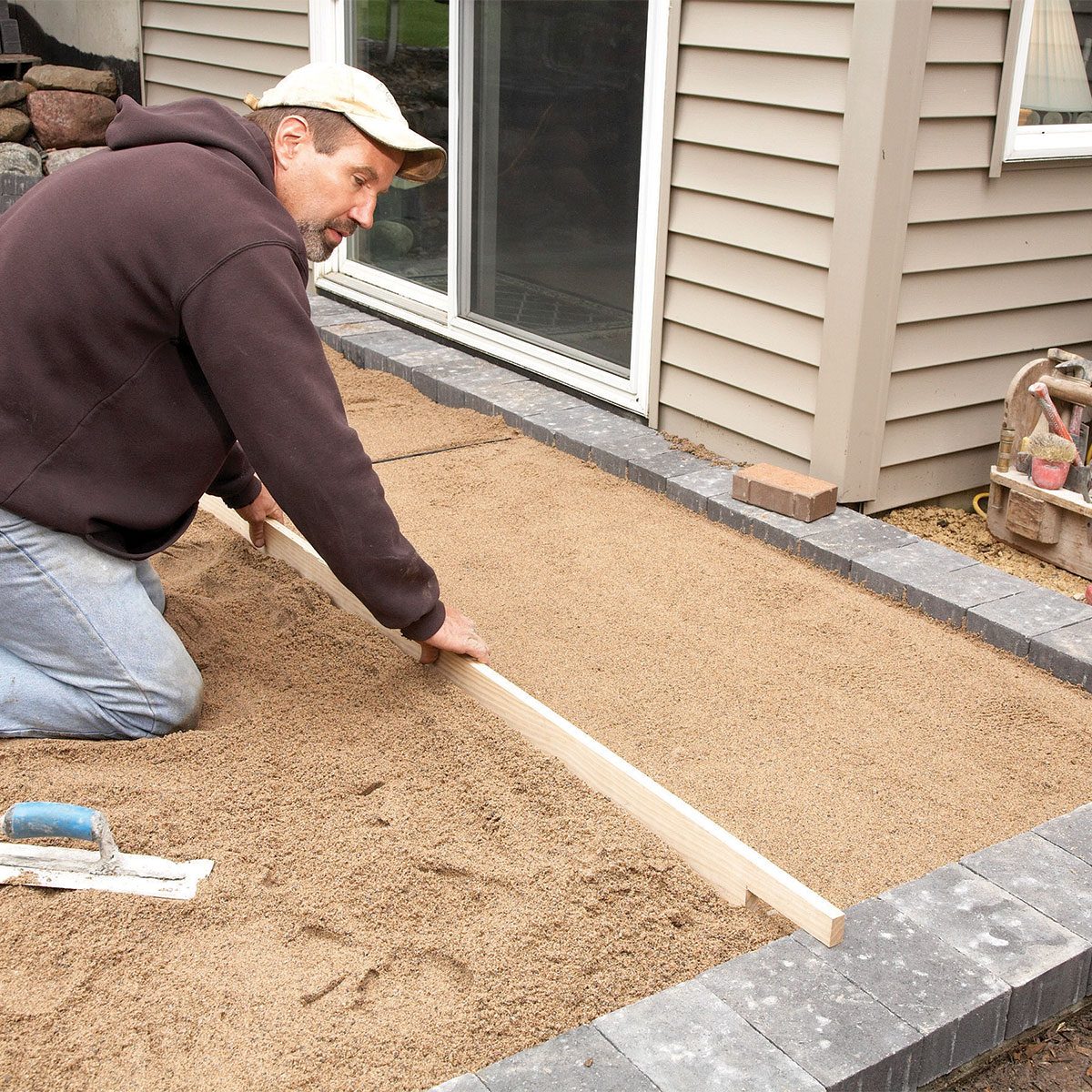 Man screeding the sand 