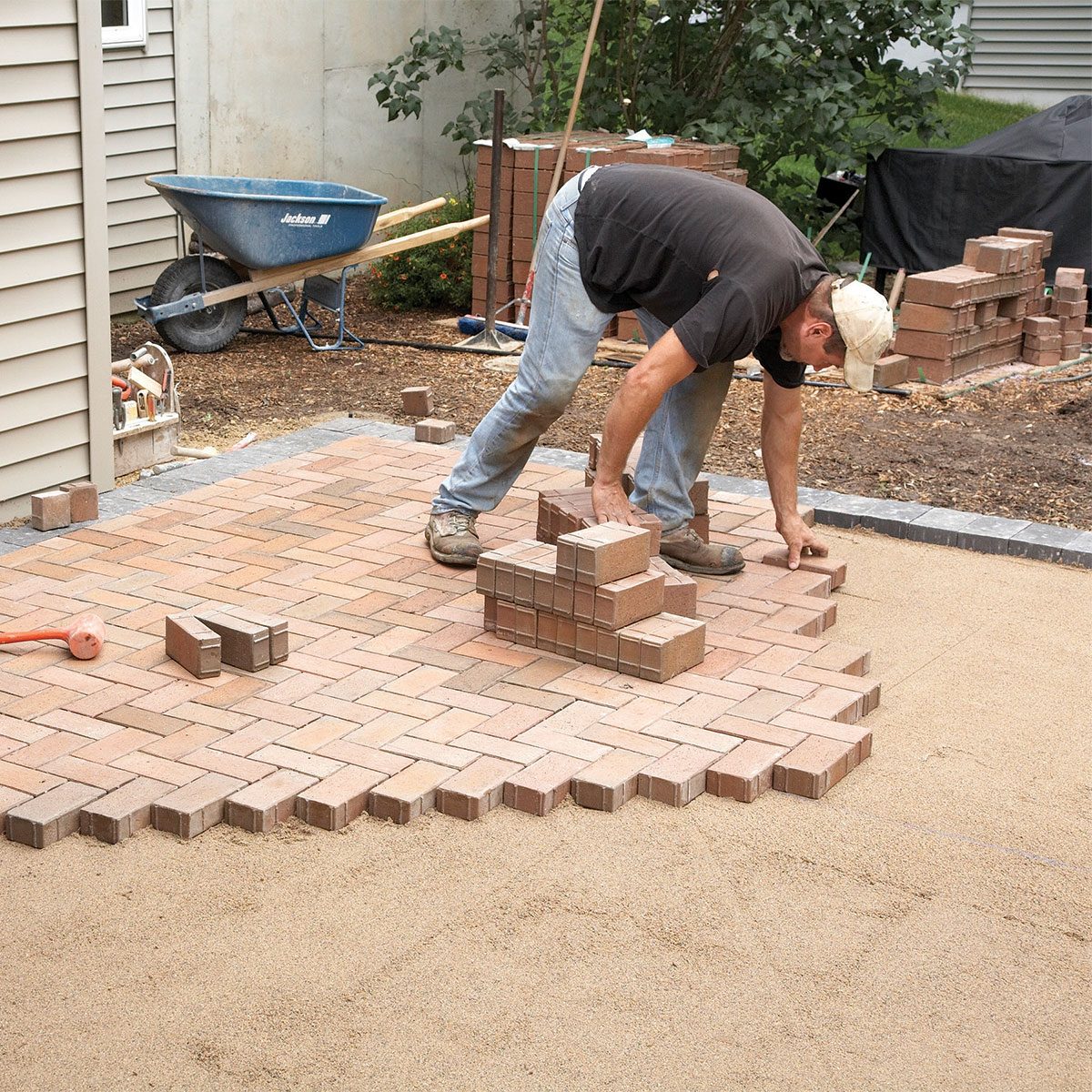 Man layering the pavers