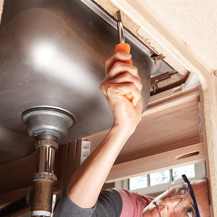 Woman Screwing on wooden piece