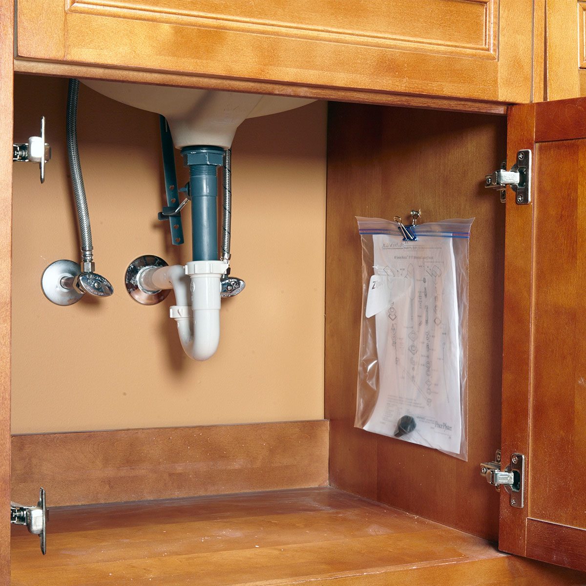 Papers and tools in plastic bag under the sink