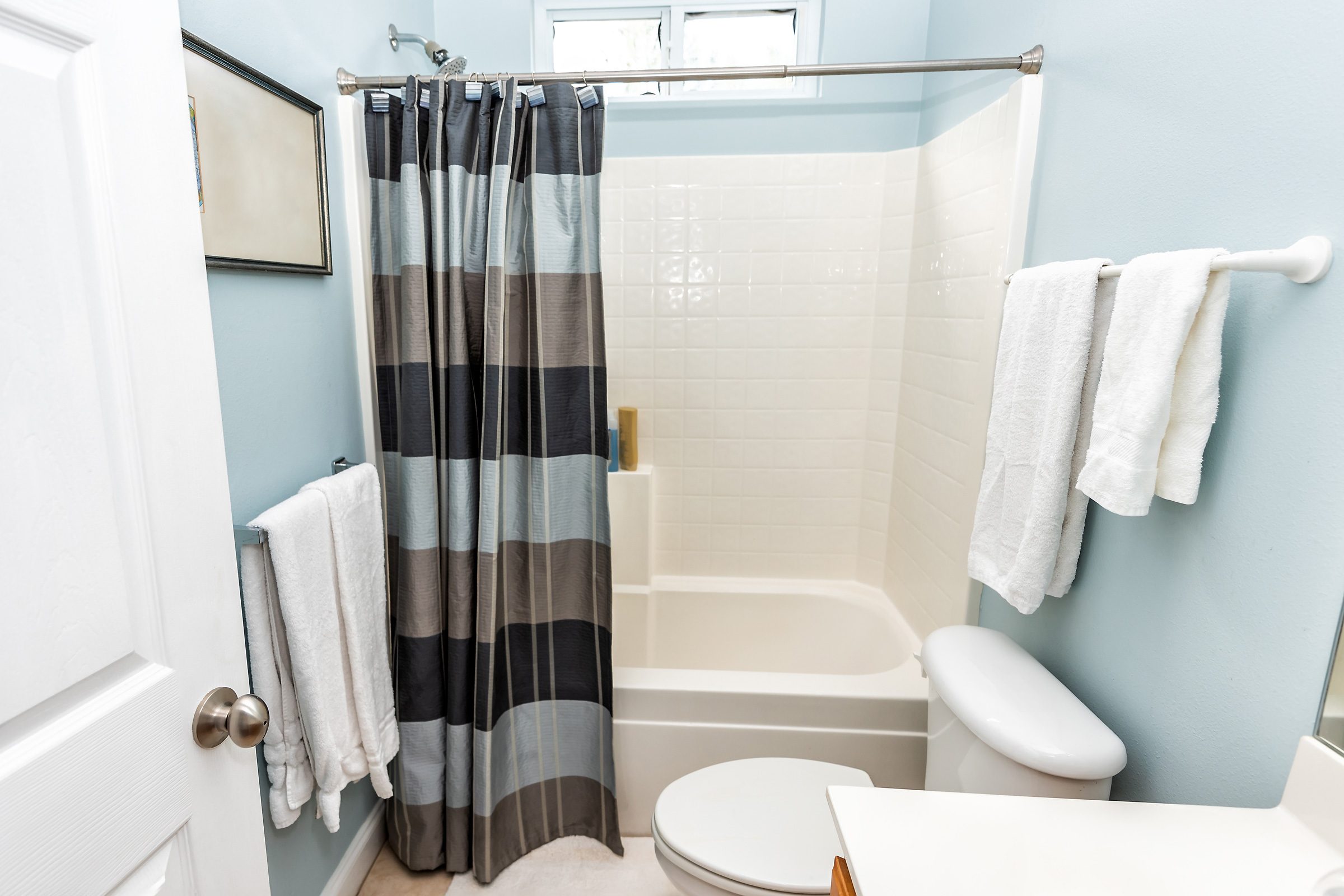 stripe shower curtain in bright bathroom