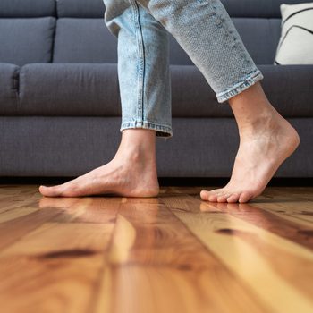 cropped shot of woman walking barefoot in room