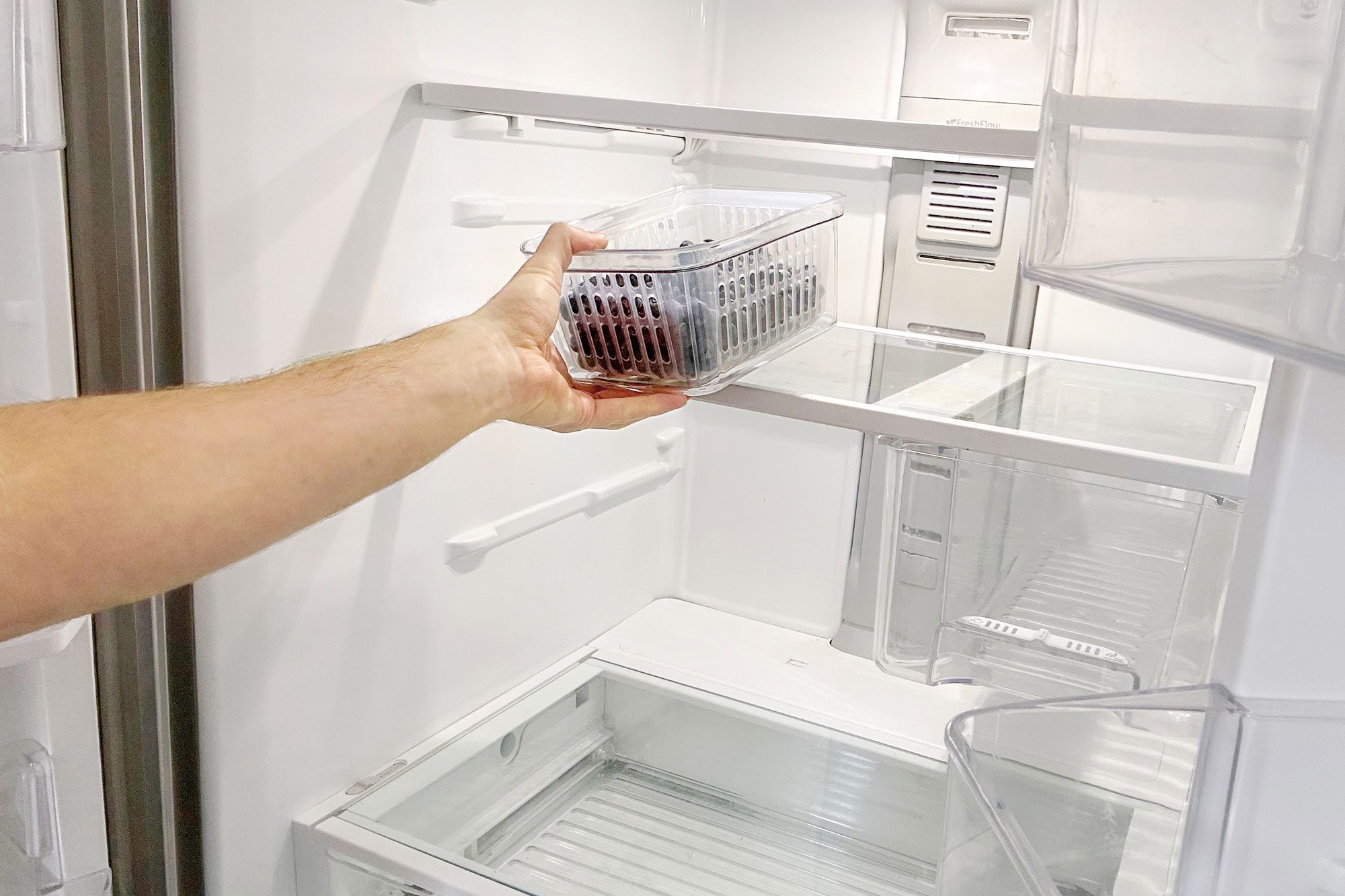 a person cleaning a Refrigerator