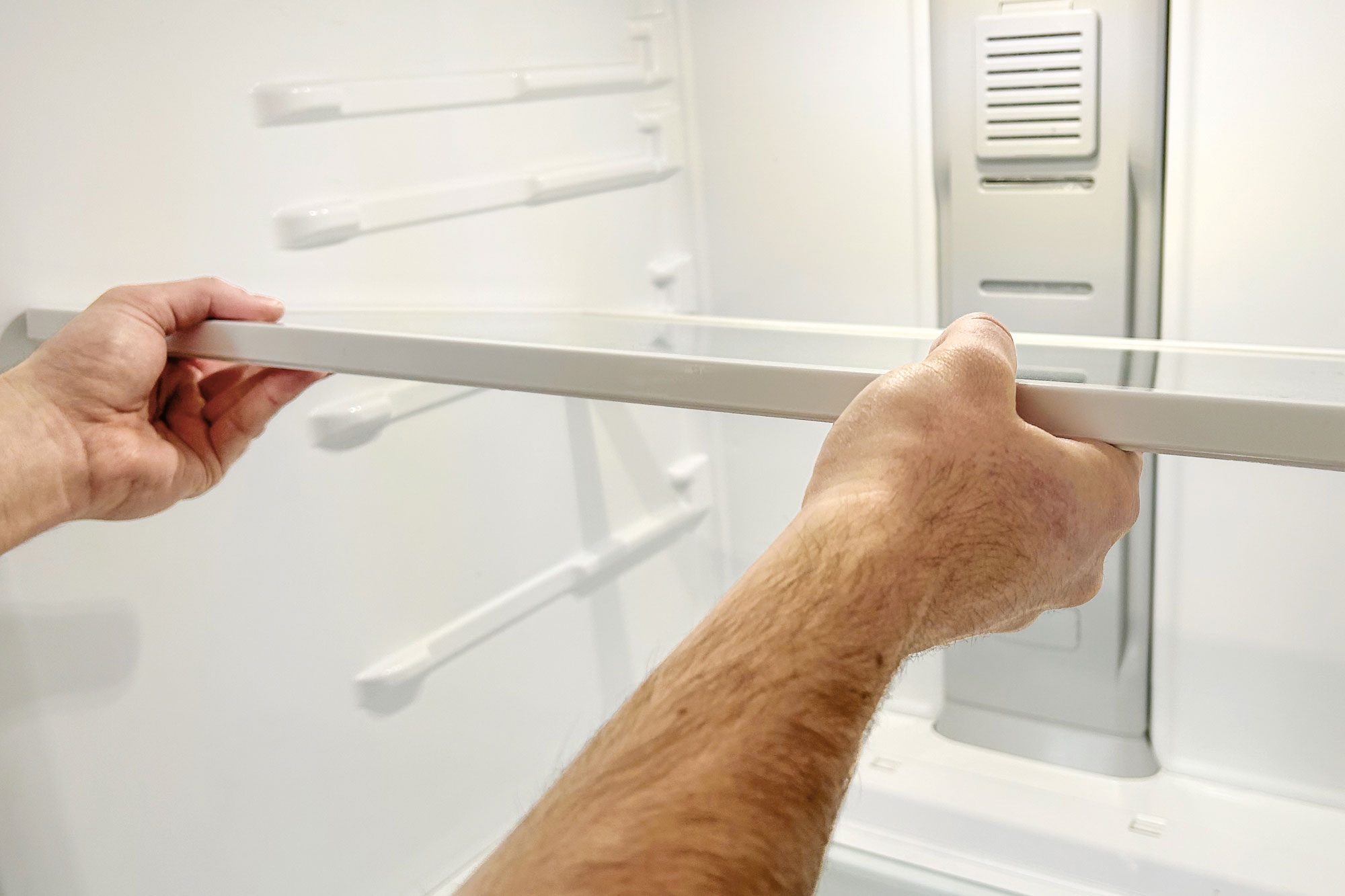 a person cleaning a Refrigerator