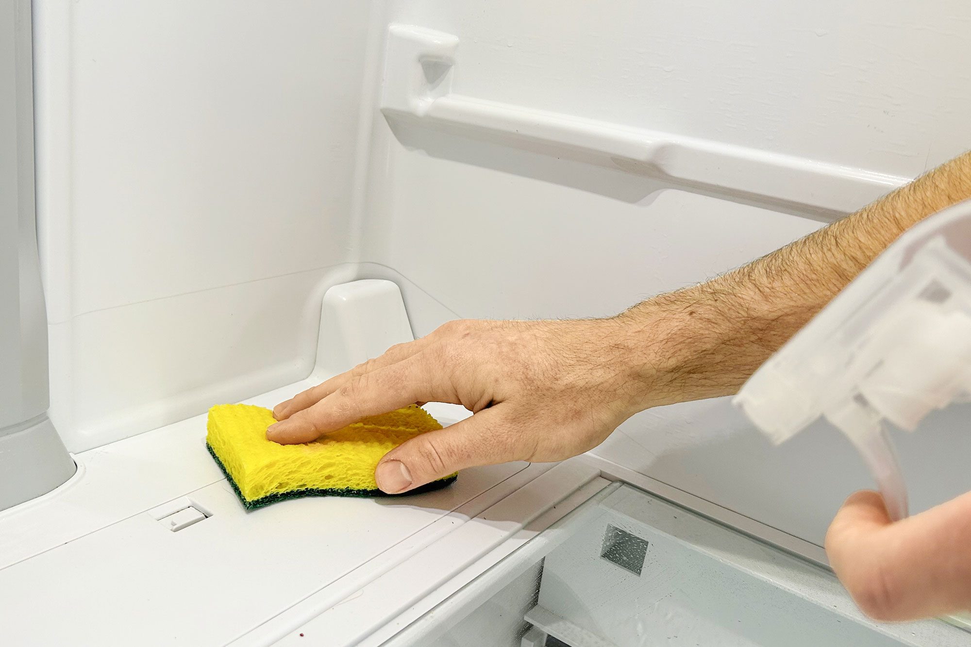 a person cleaning a Refrigerator