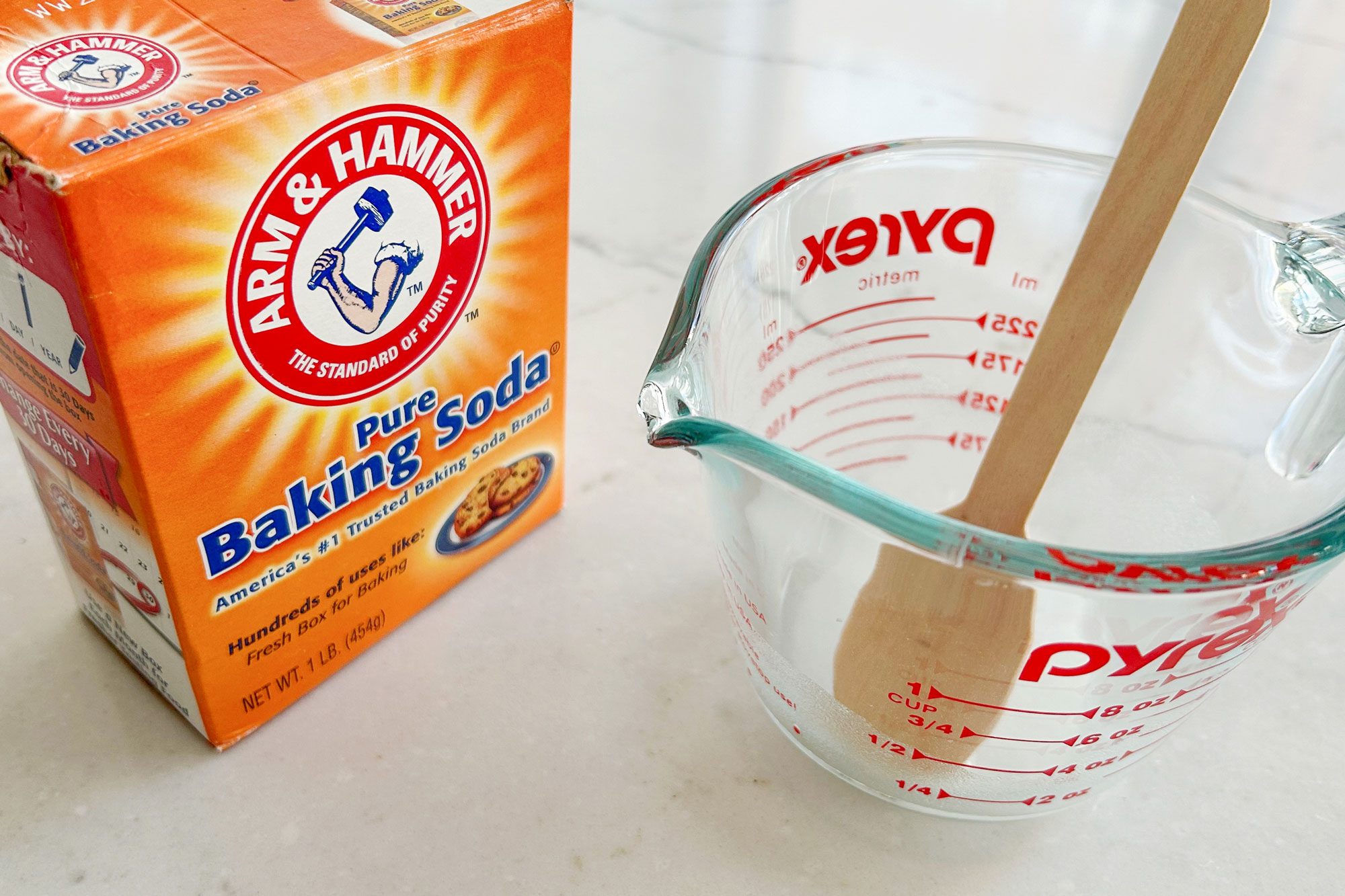 baking soda; mixing beaker; wooden spatula;