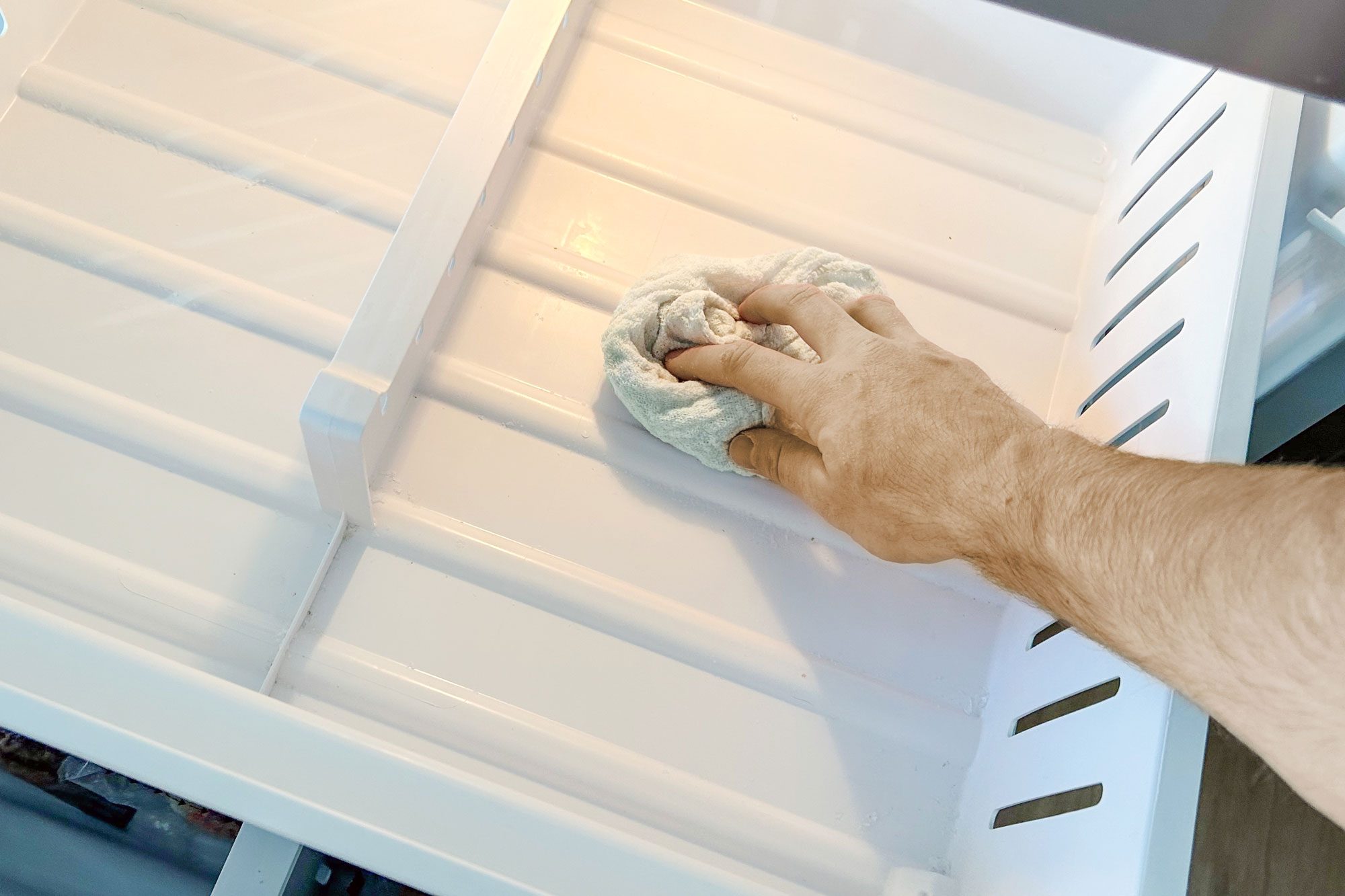 a person cleaning a Refrigerator