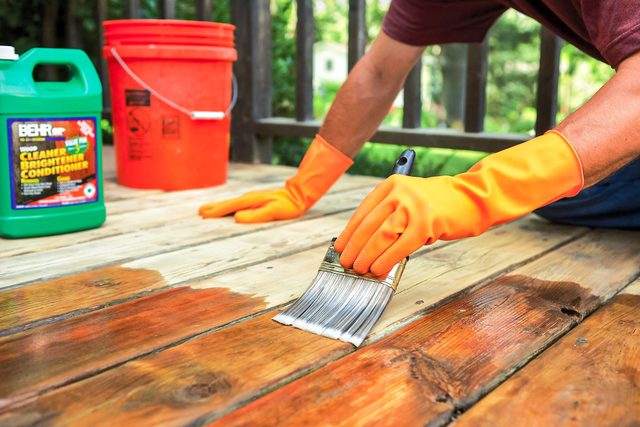 applying deck conditioner using brush
