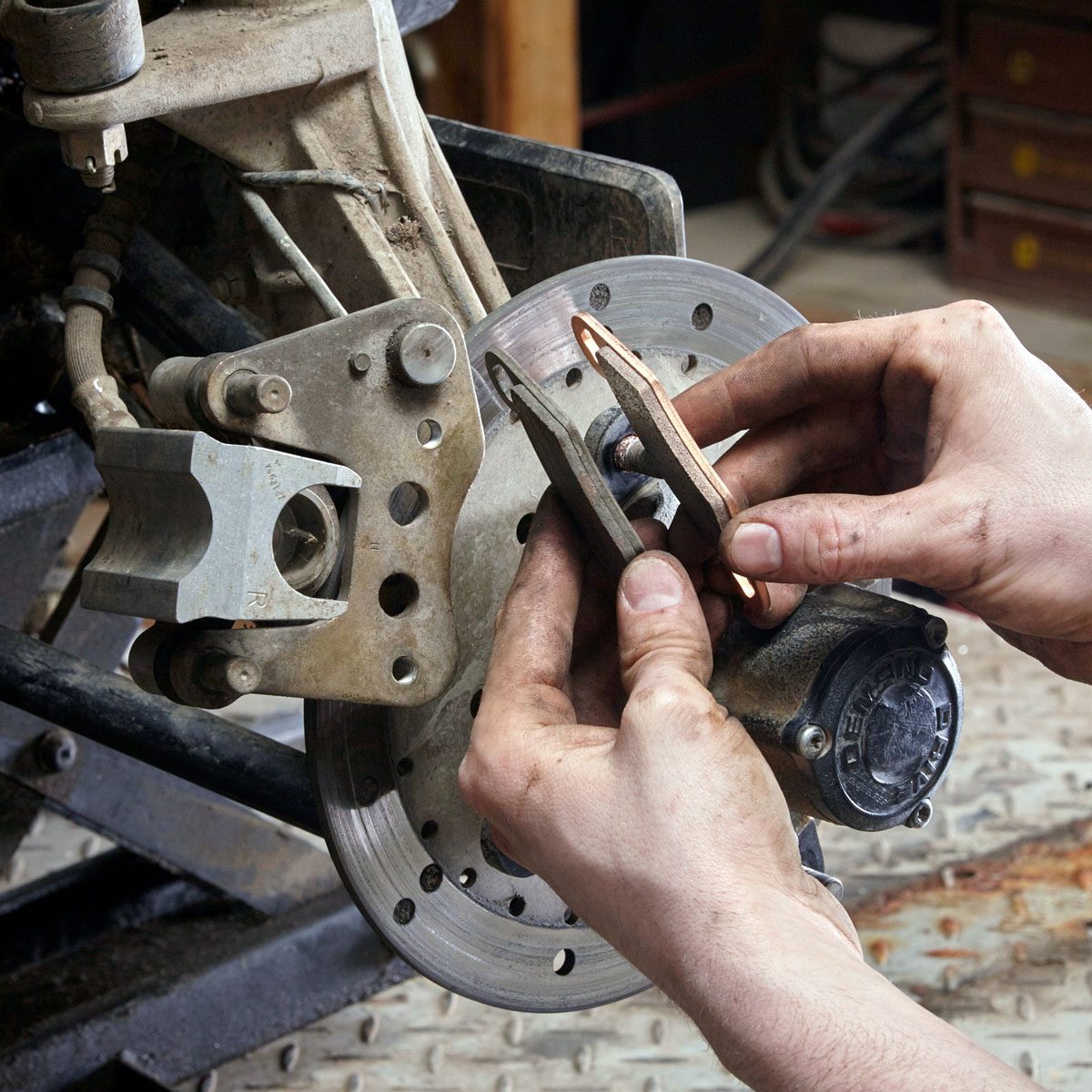 hands can be seen checking brakes