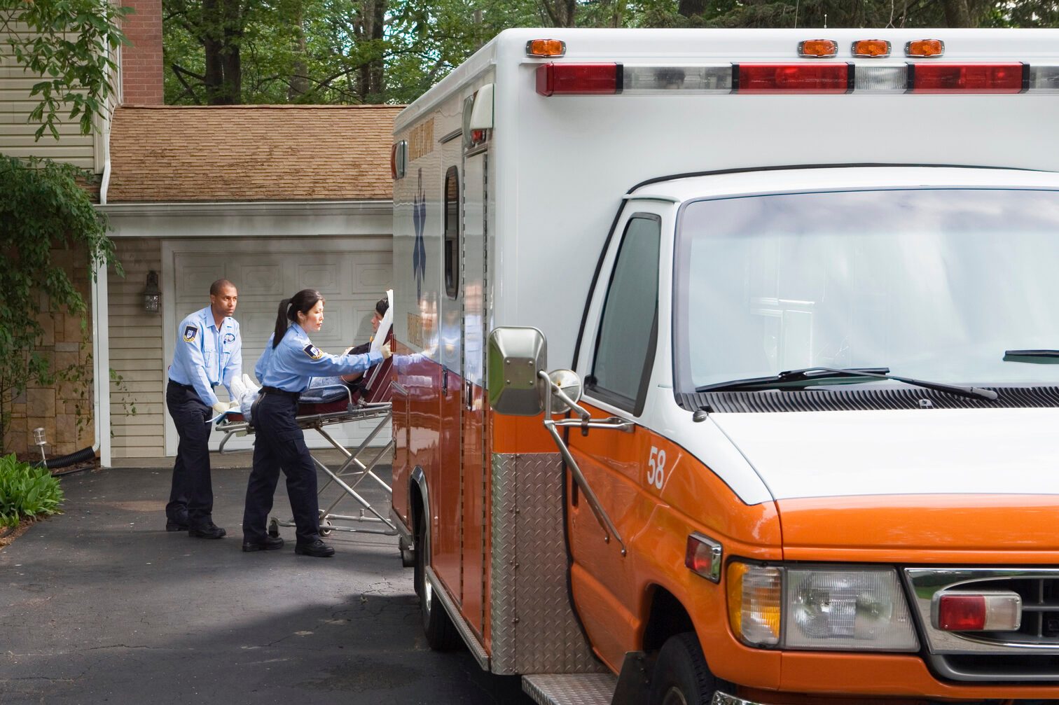 Paramedics putting person into ambulance