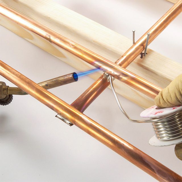 Ladder being soldered to the frame.