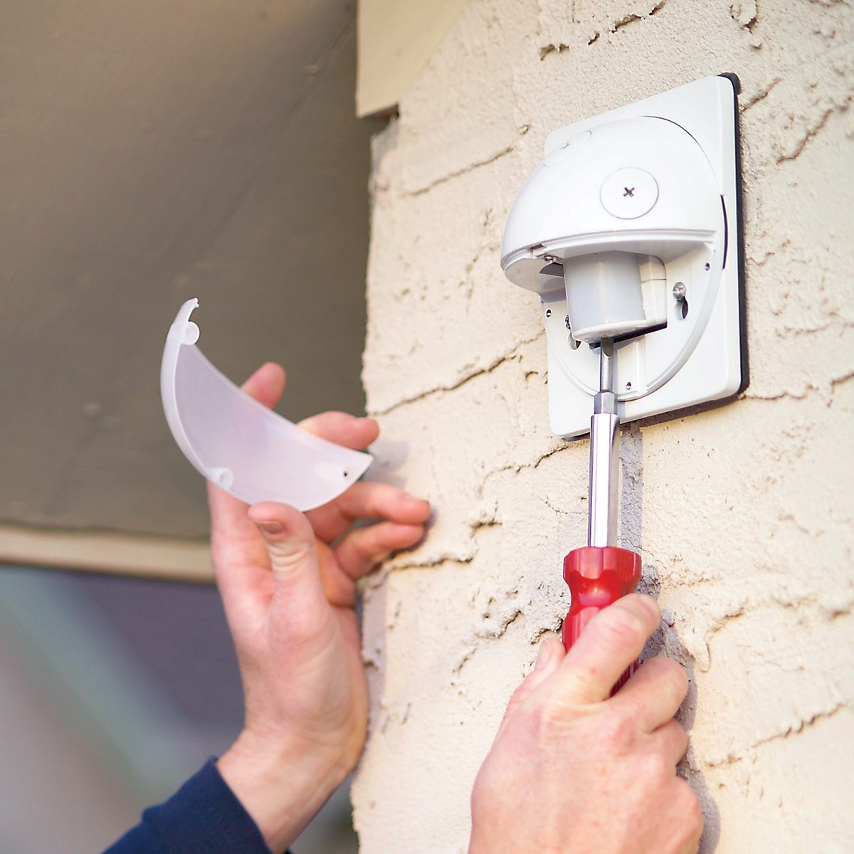 A person adjusting sensor sensitivity.