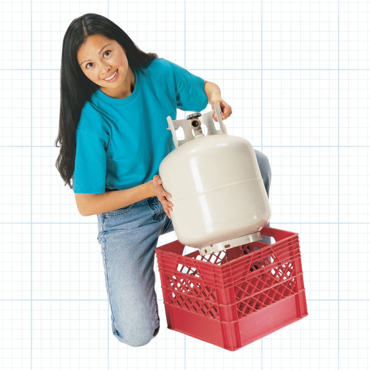 A person wearing a teal shirt and jeans kneels next to a red plastic crate, positioning a propane tank into it. The background is a white grid.