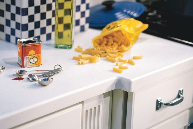 Chips, oil and can of paprika on kitchen countertop