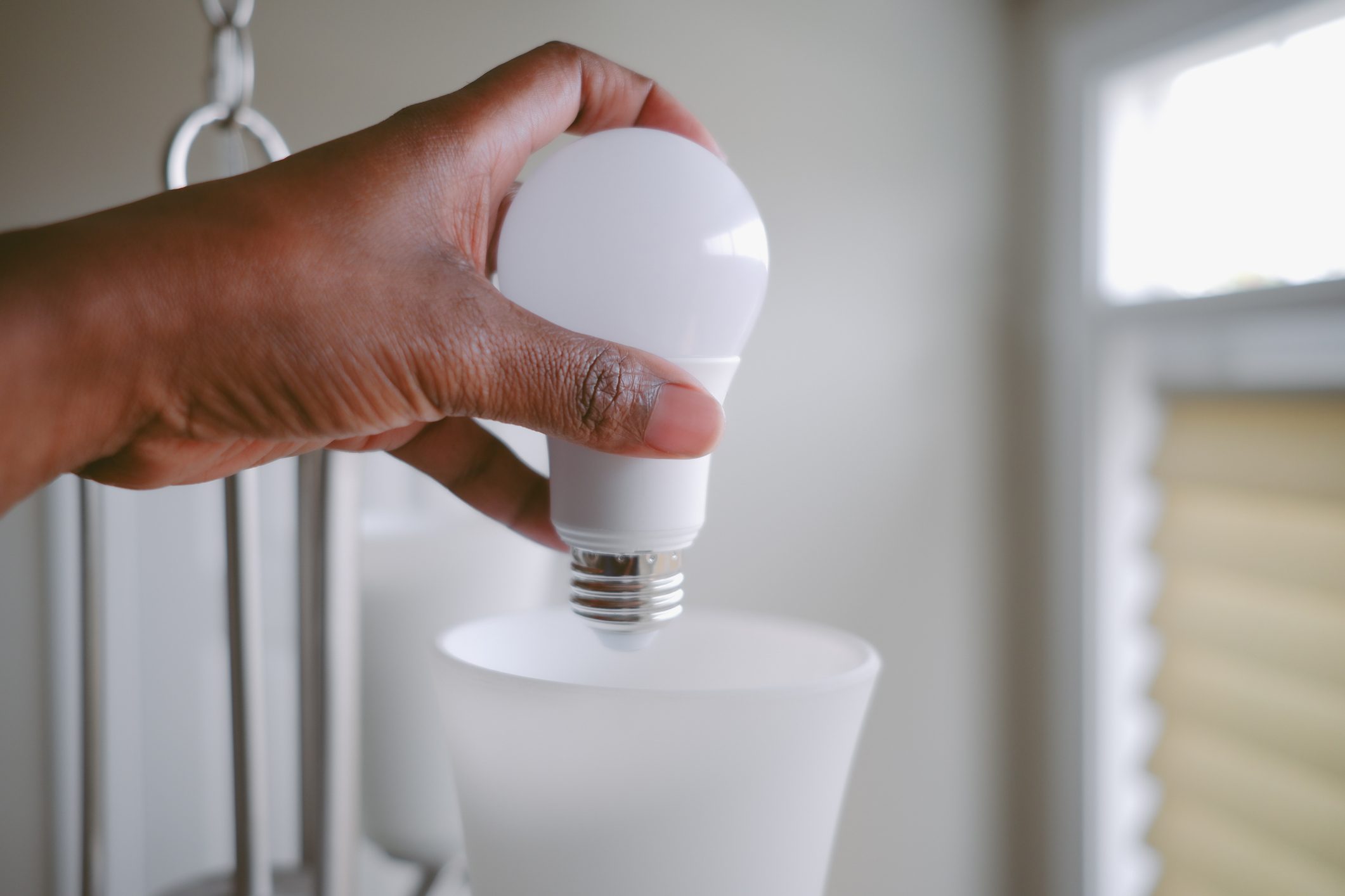 Woman Changes LED Light Bulb