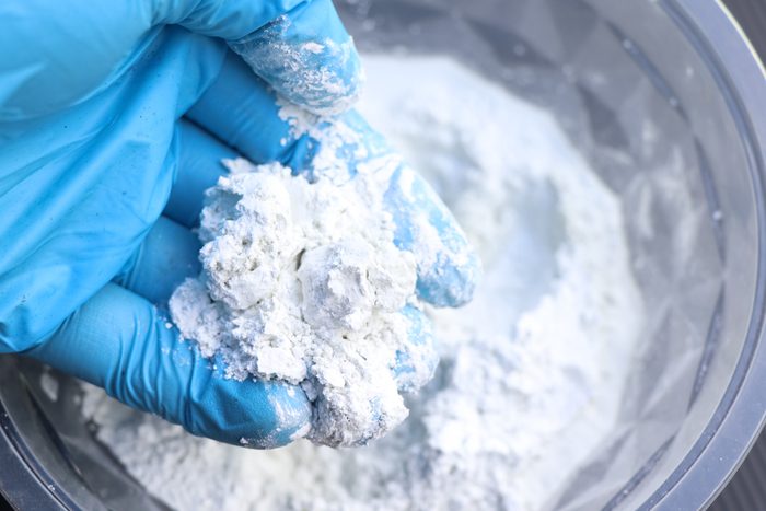 mixing grout in a bucket for mechanic work