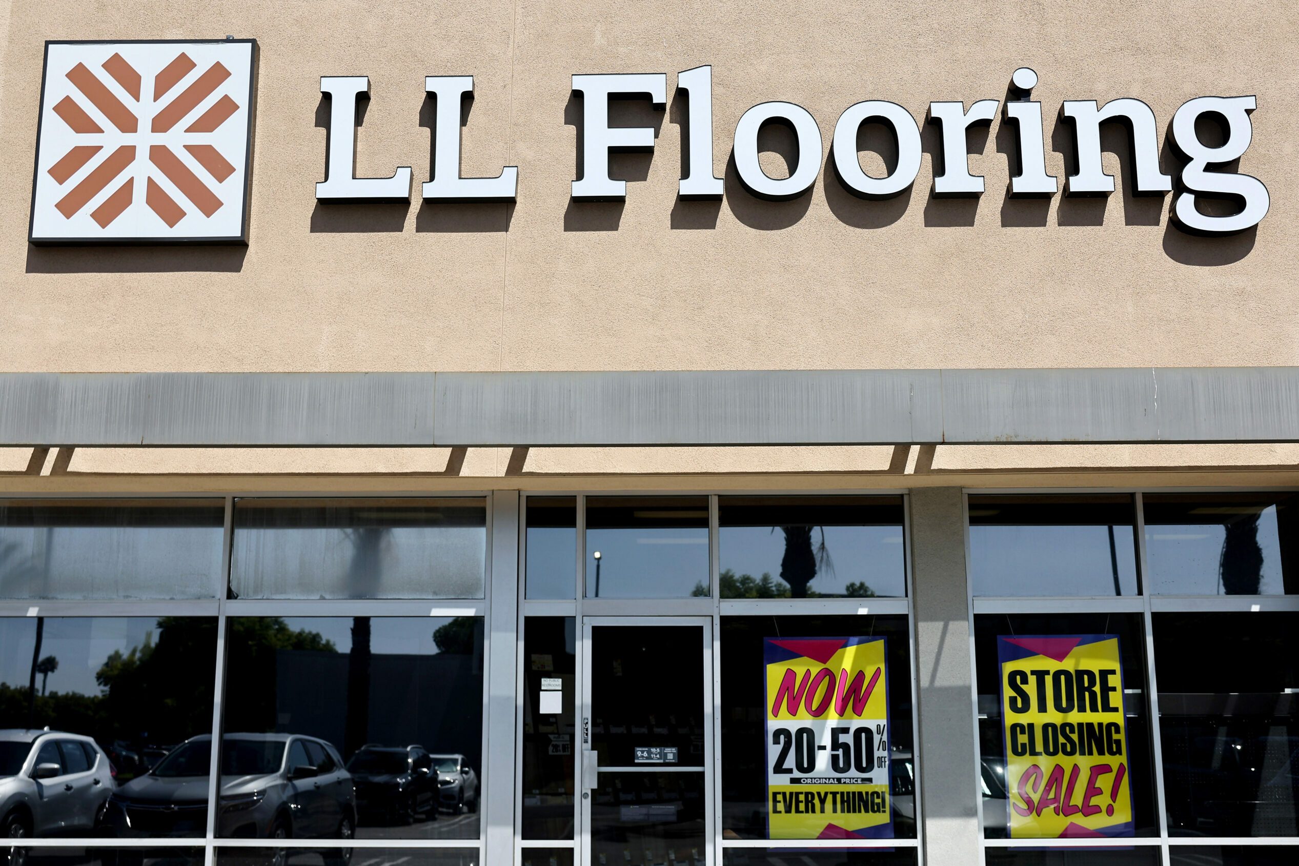 LL Flooring store with Store Closing Sale signs in the window