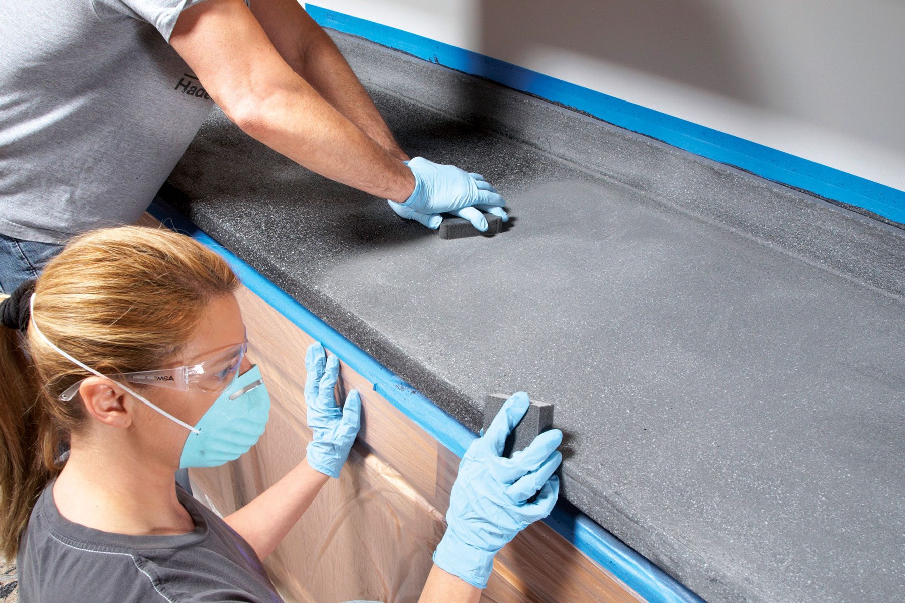 Sanding and smoothing countertop surface.