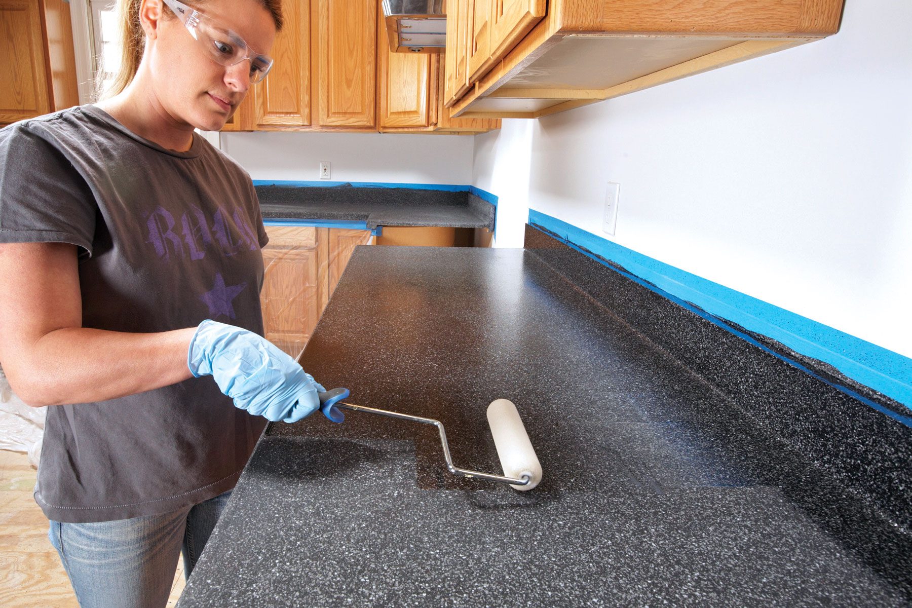 Applying topcoat to the countertop surface.