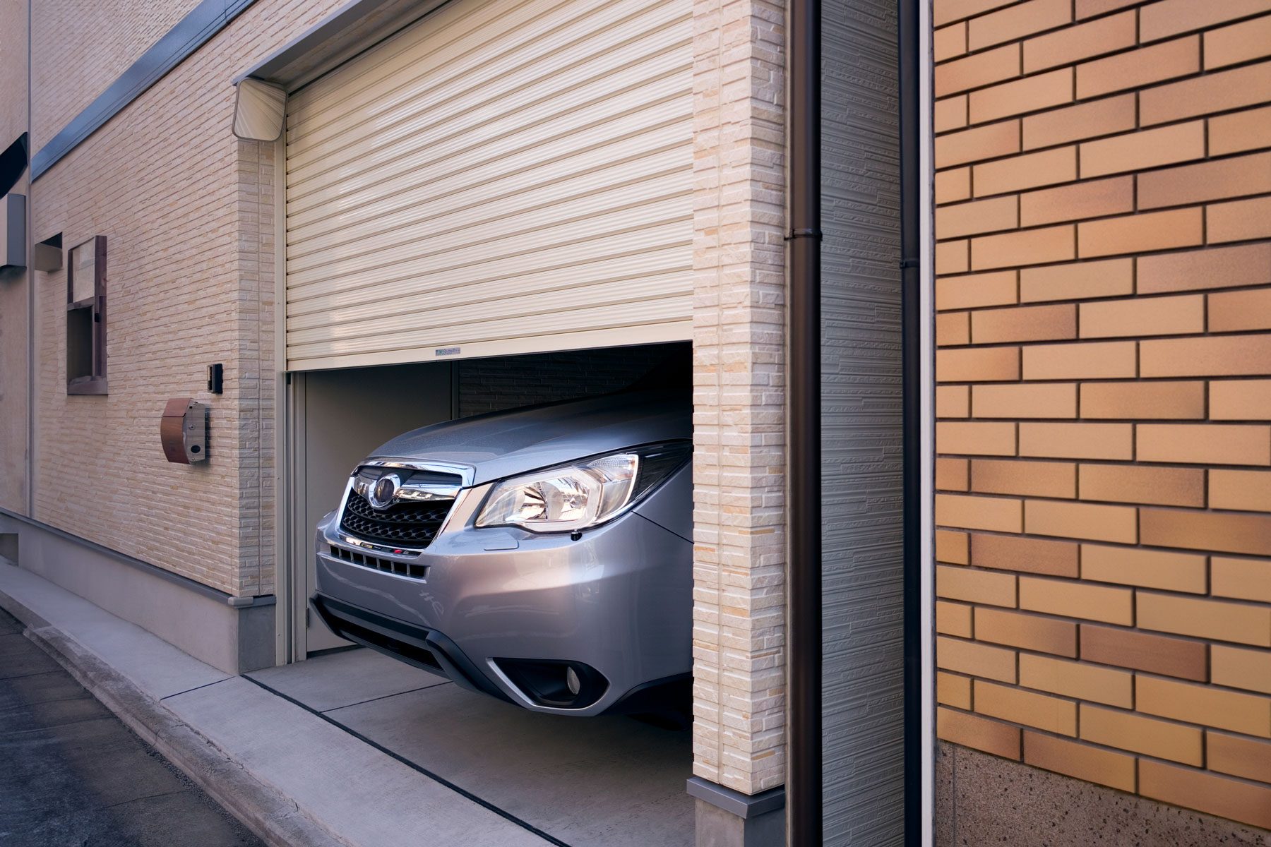 Nose of large car sticking out of garage