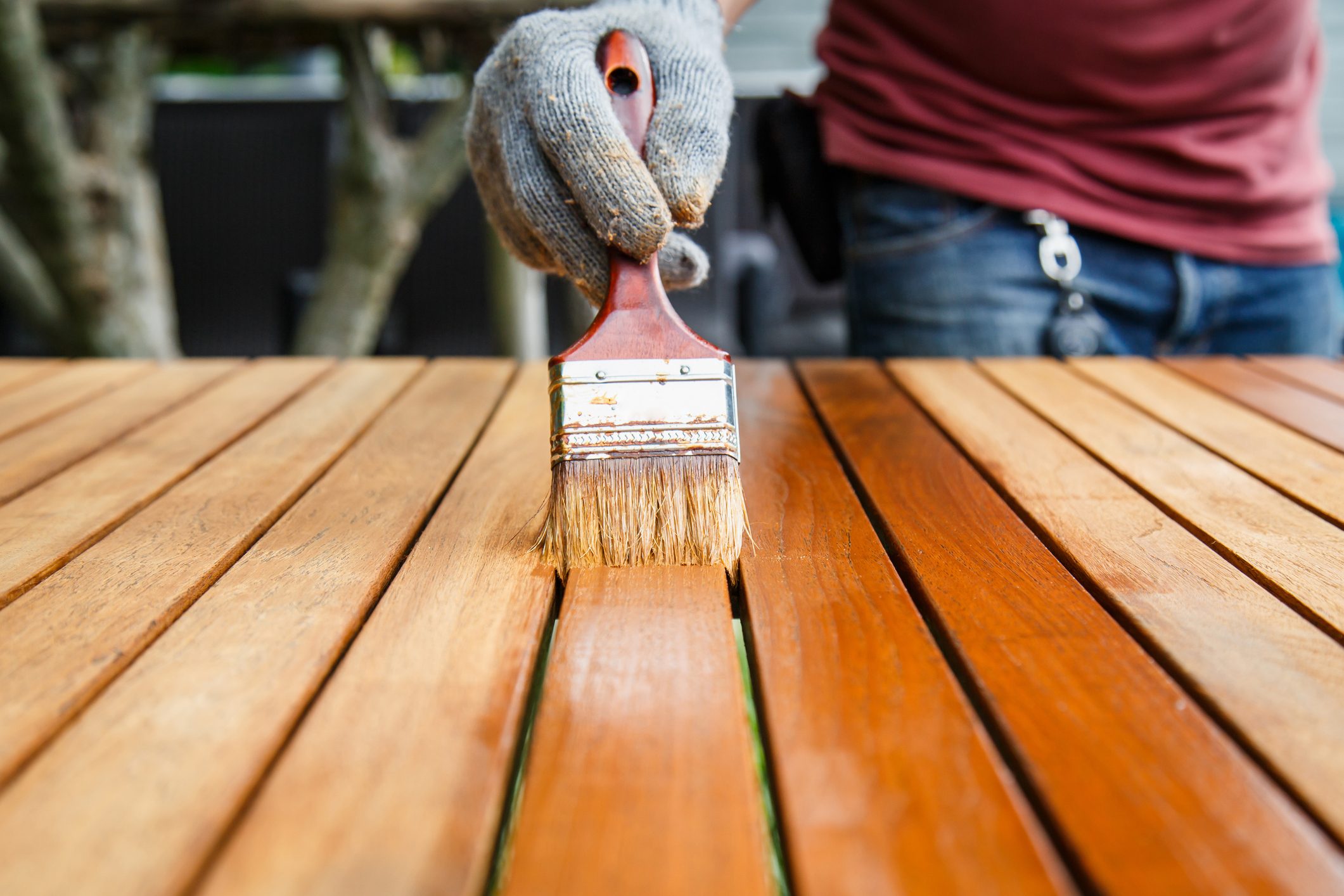 Brush in hand and painting on the wooden table