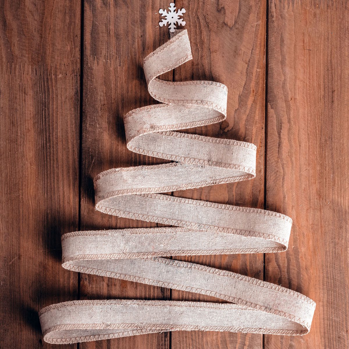 Christmas Tree Made Of Linen Ribbon On A Wooden Background