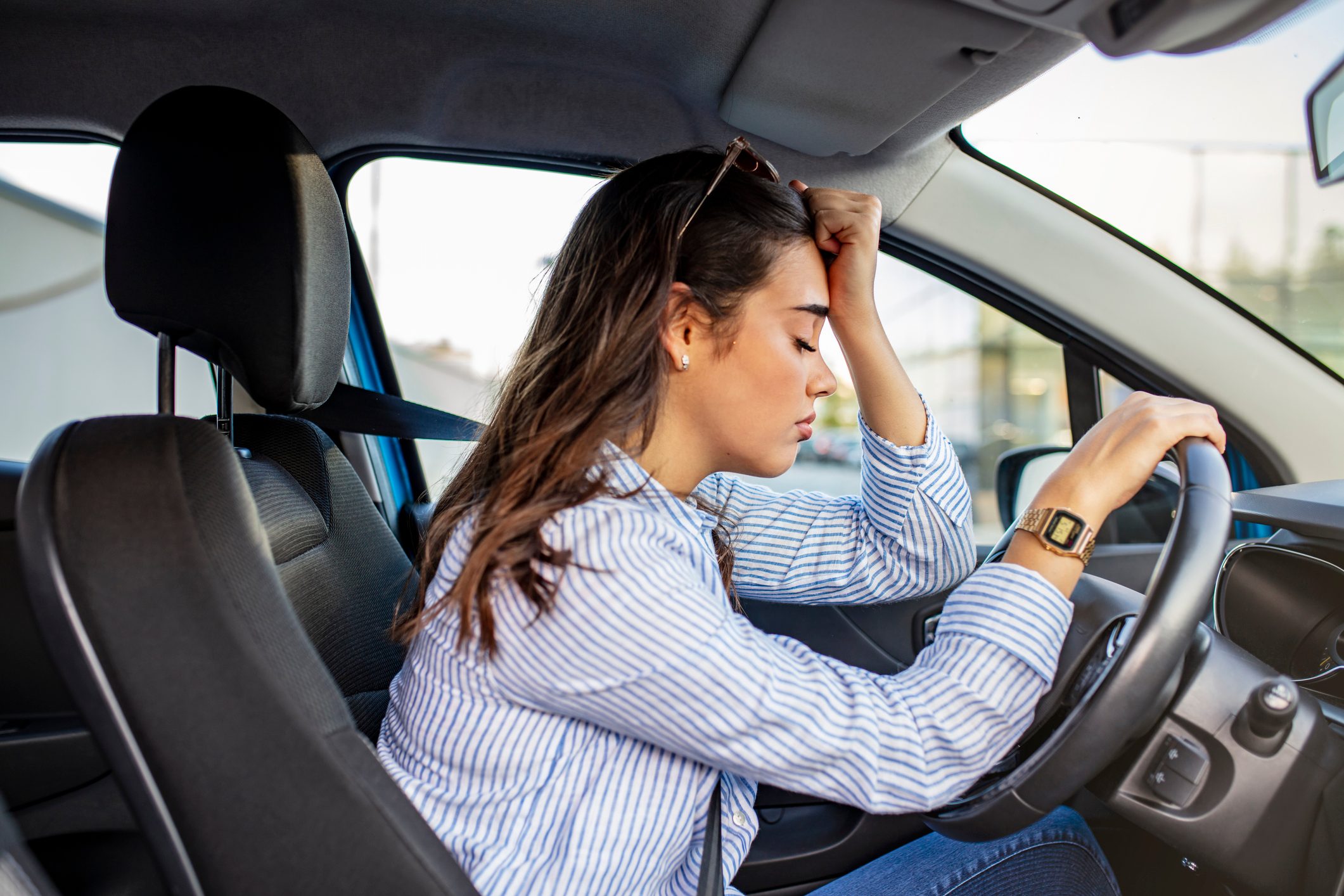 Stressed woman in a driver's seat of a car
