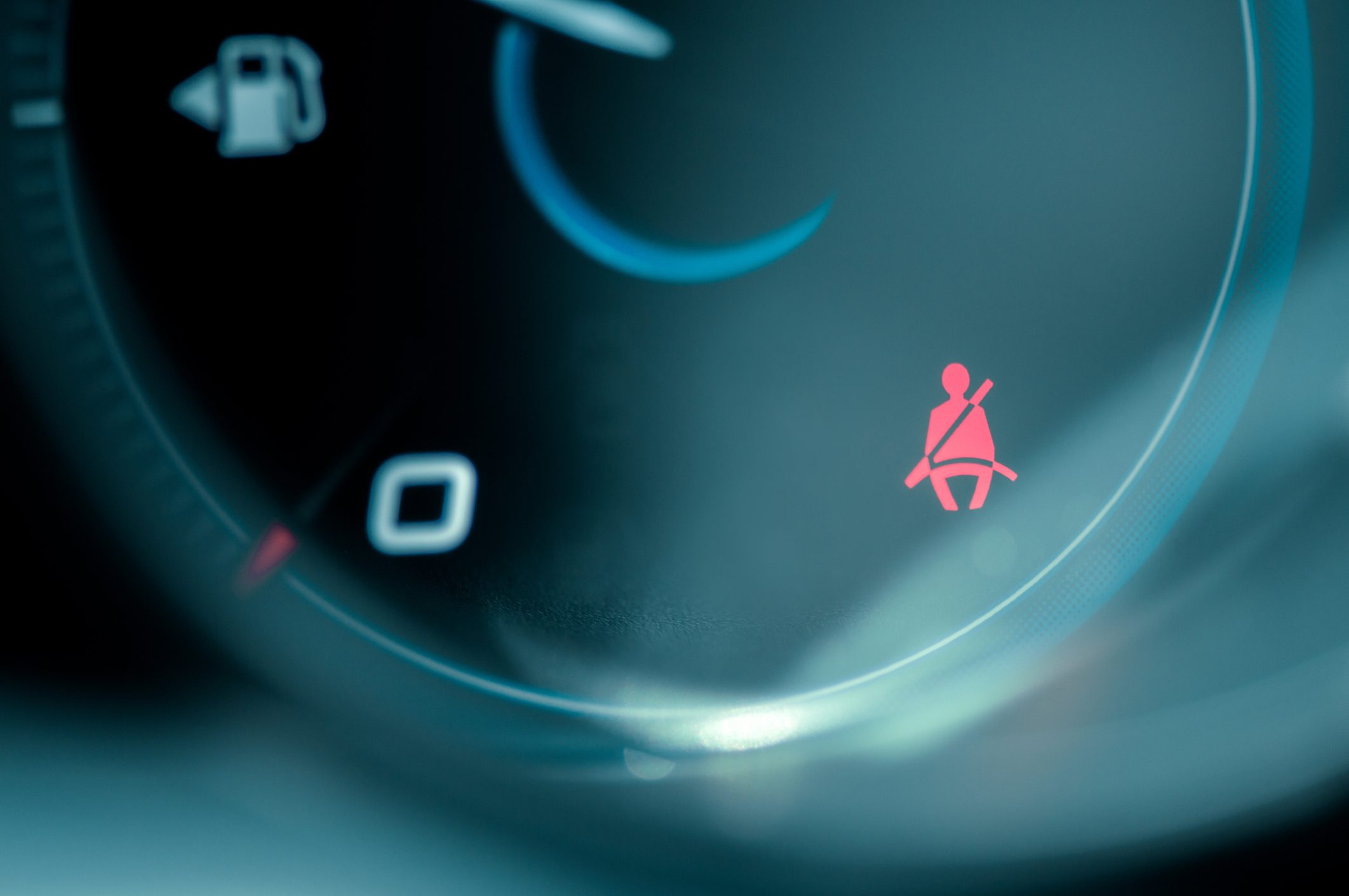 Close-up on car dashboard and warning safety belt light icon