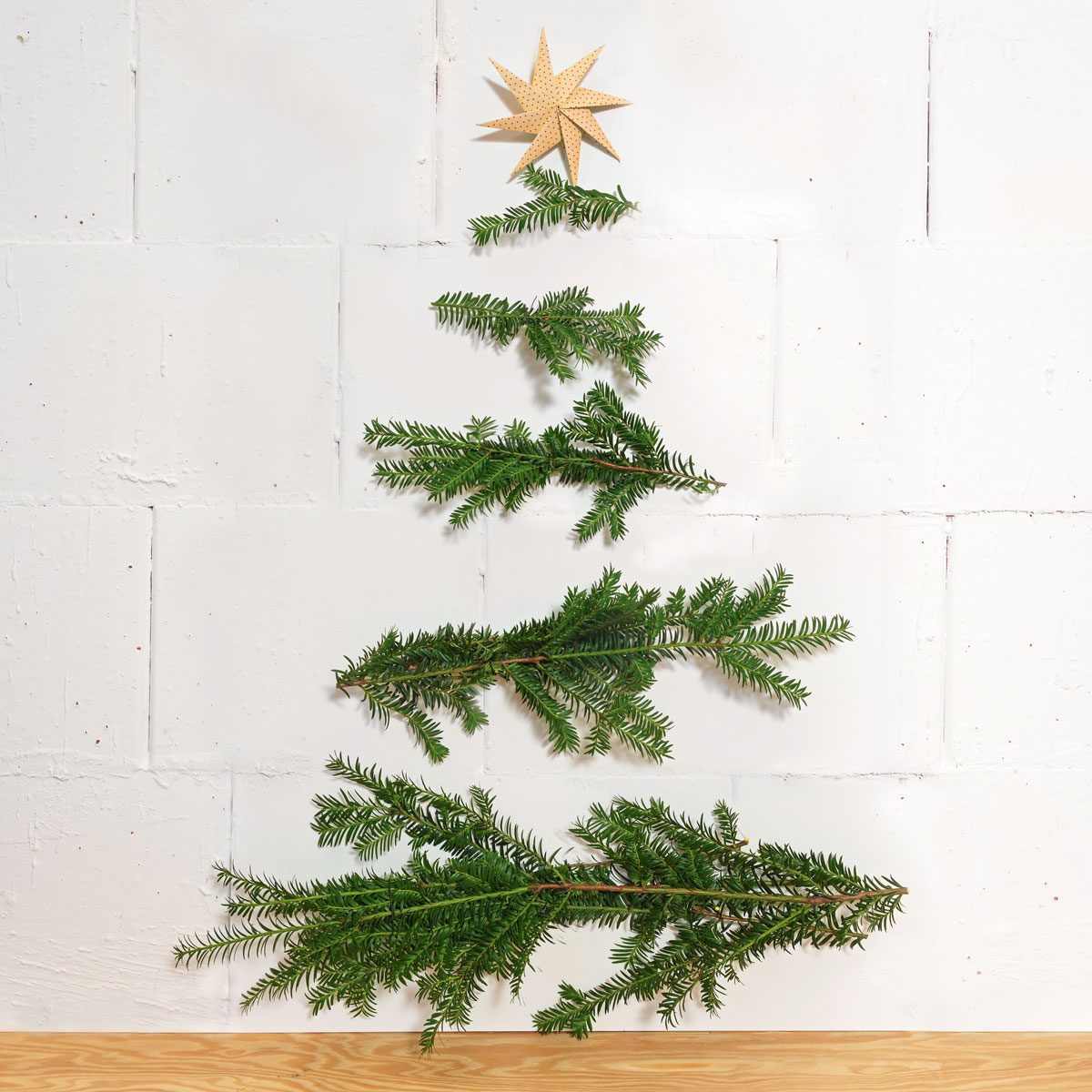 Homemade Christmas Decoration Made Of Natural Branches Nailed Horizontally To The Wall