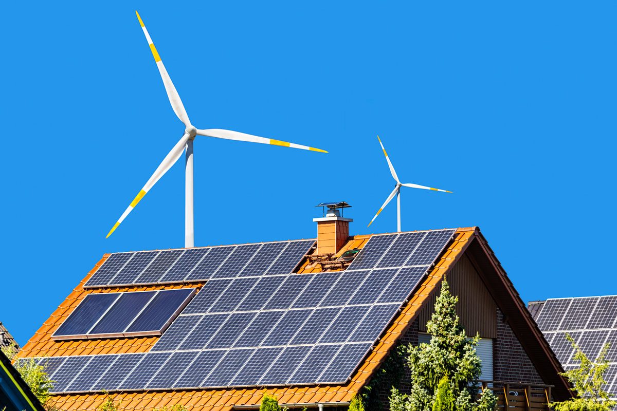 house with solar panels and wind energy