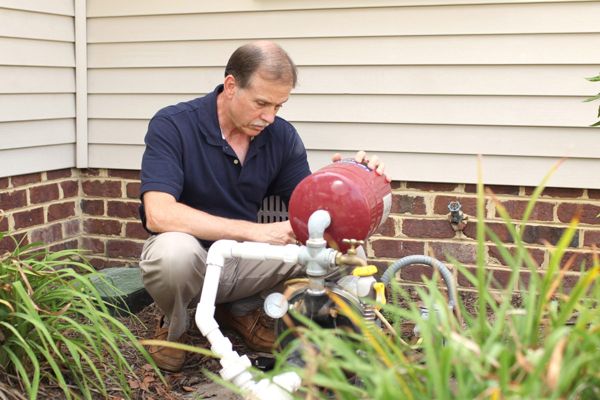 man working on well pump