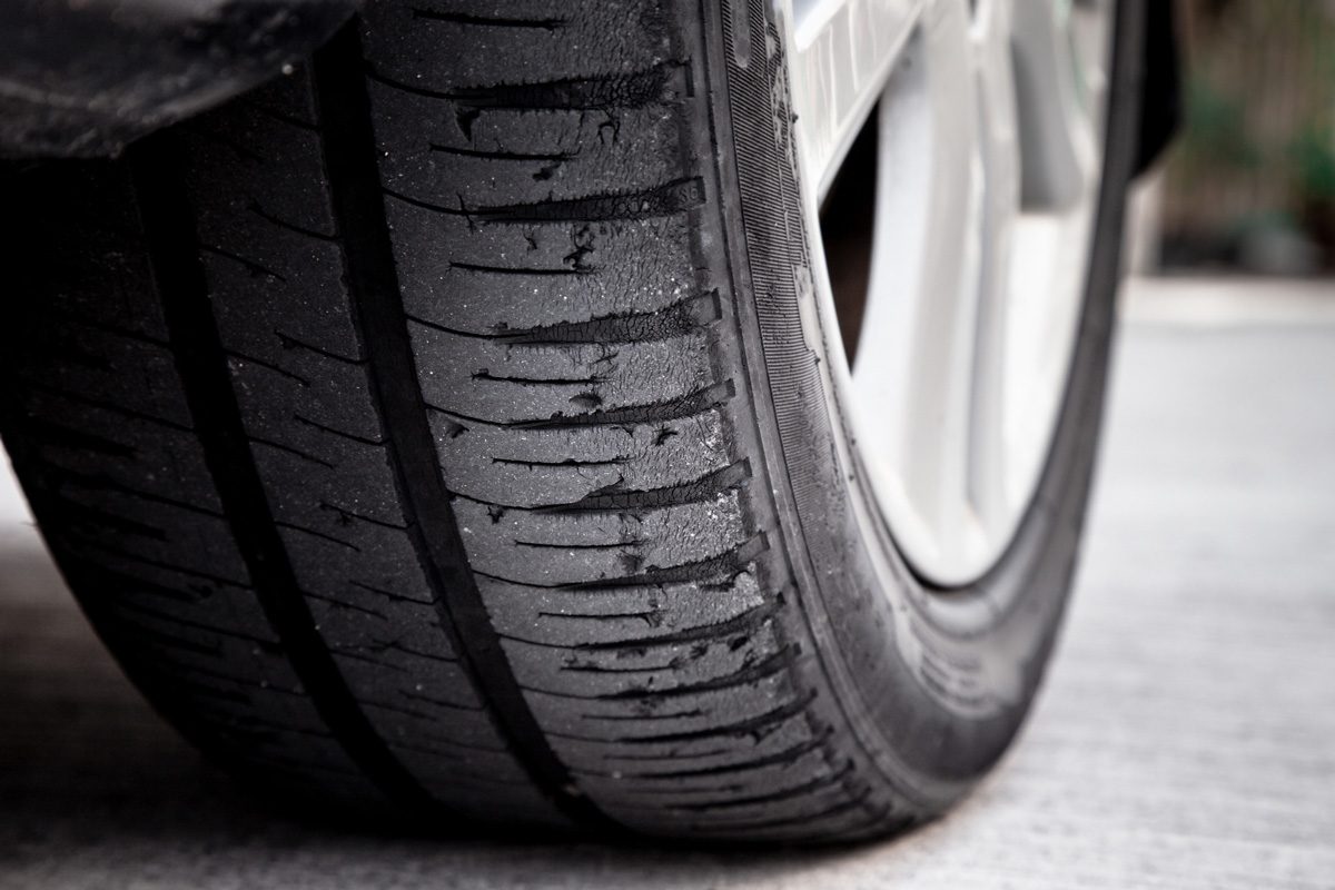 old car bald tire with very little tread remaining