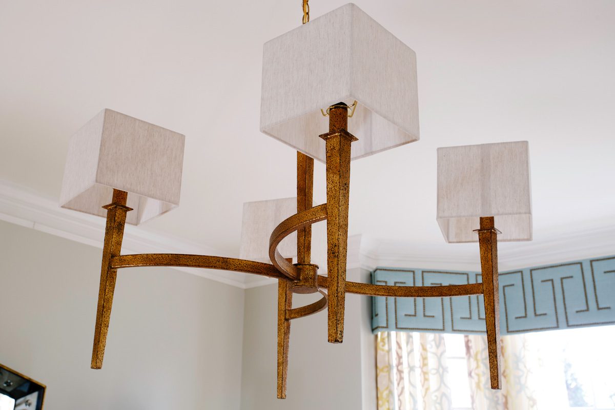 rustic chandelier with several white square lampshades