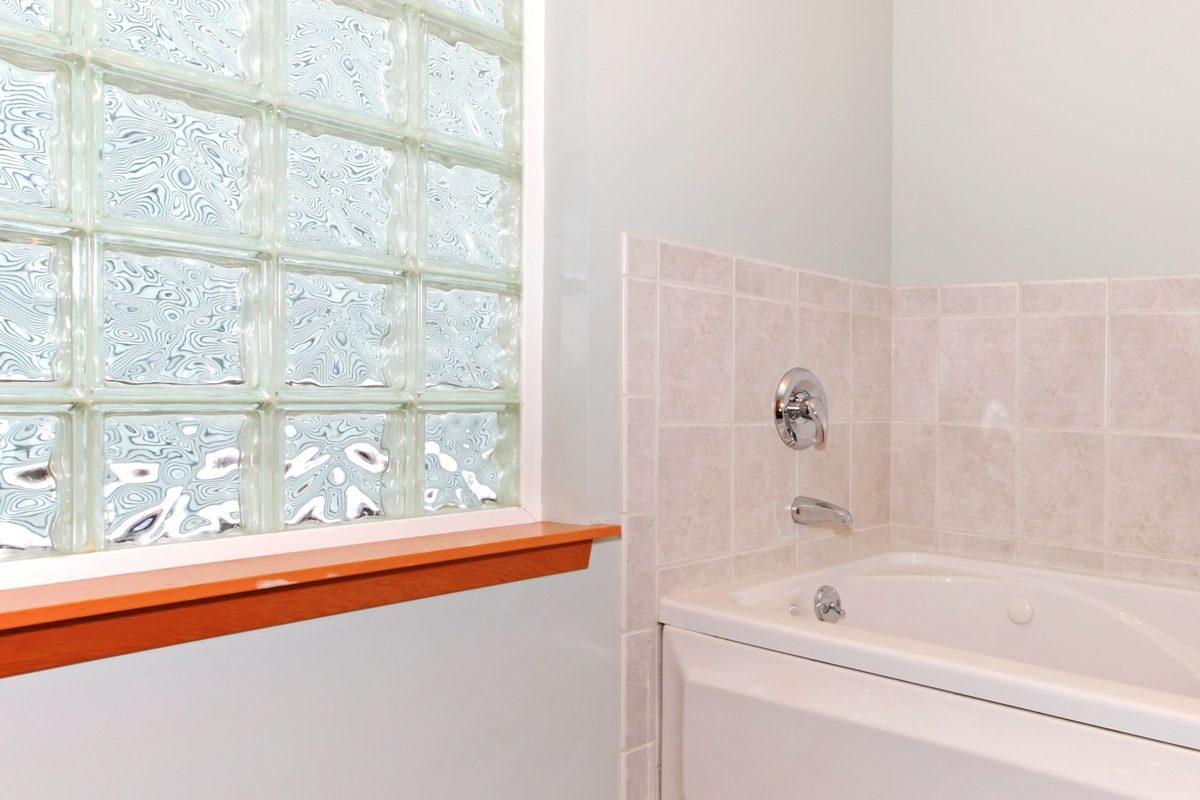 bathroom with glass block window